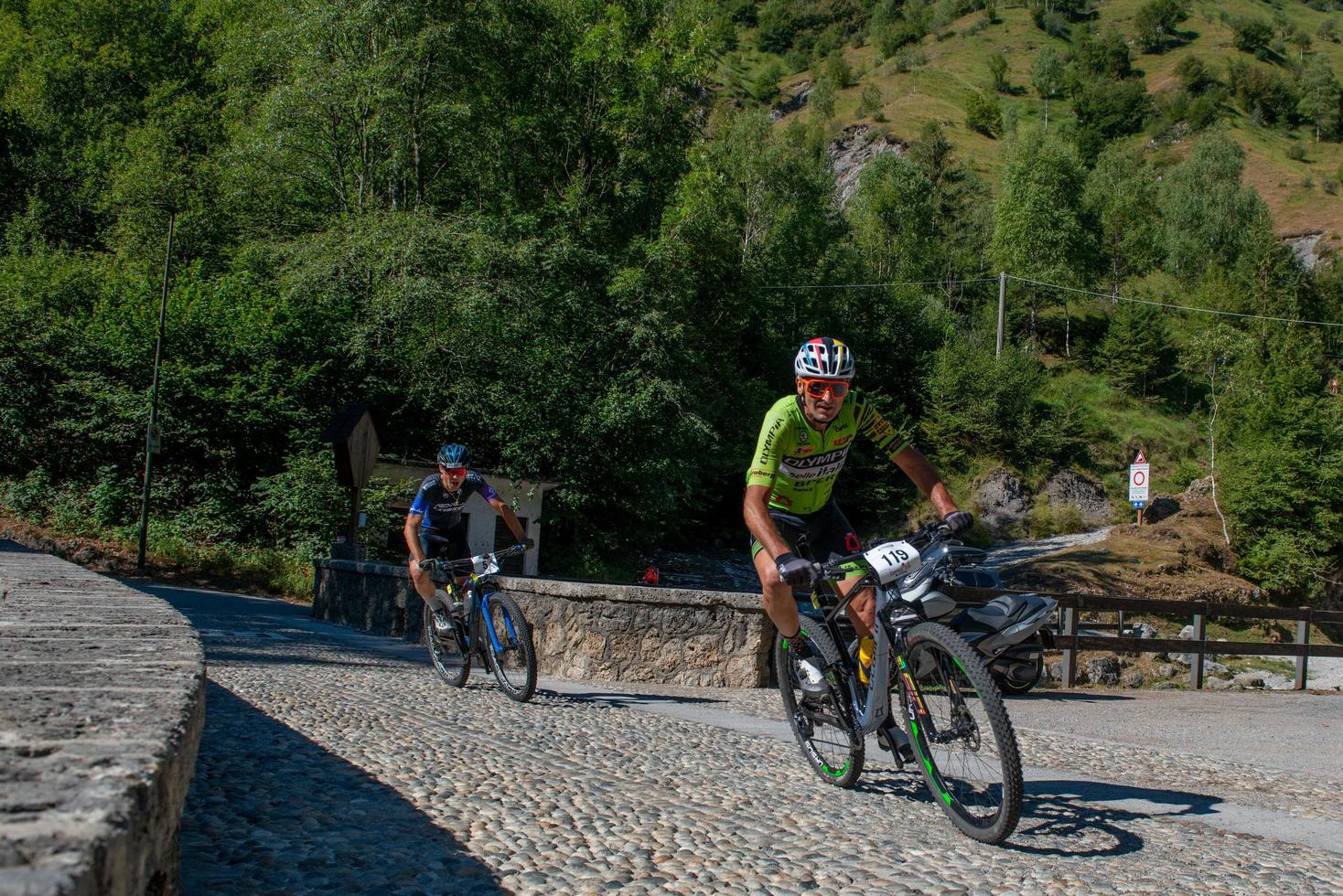 Italy  2022 Cyclists traveling on challenging trails on mountain bikes photo