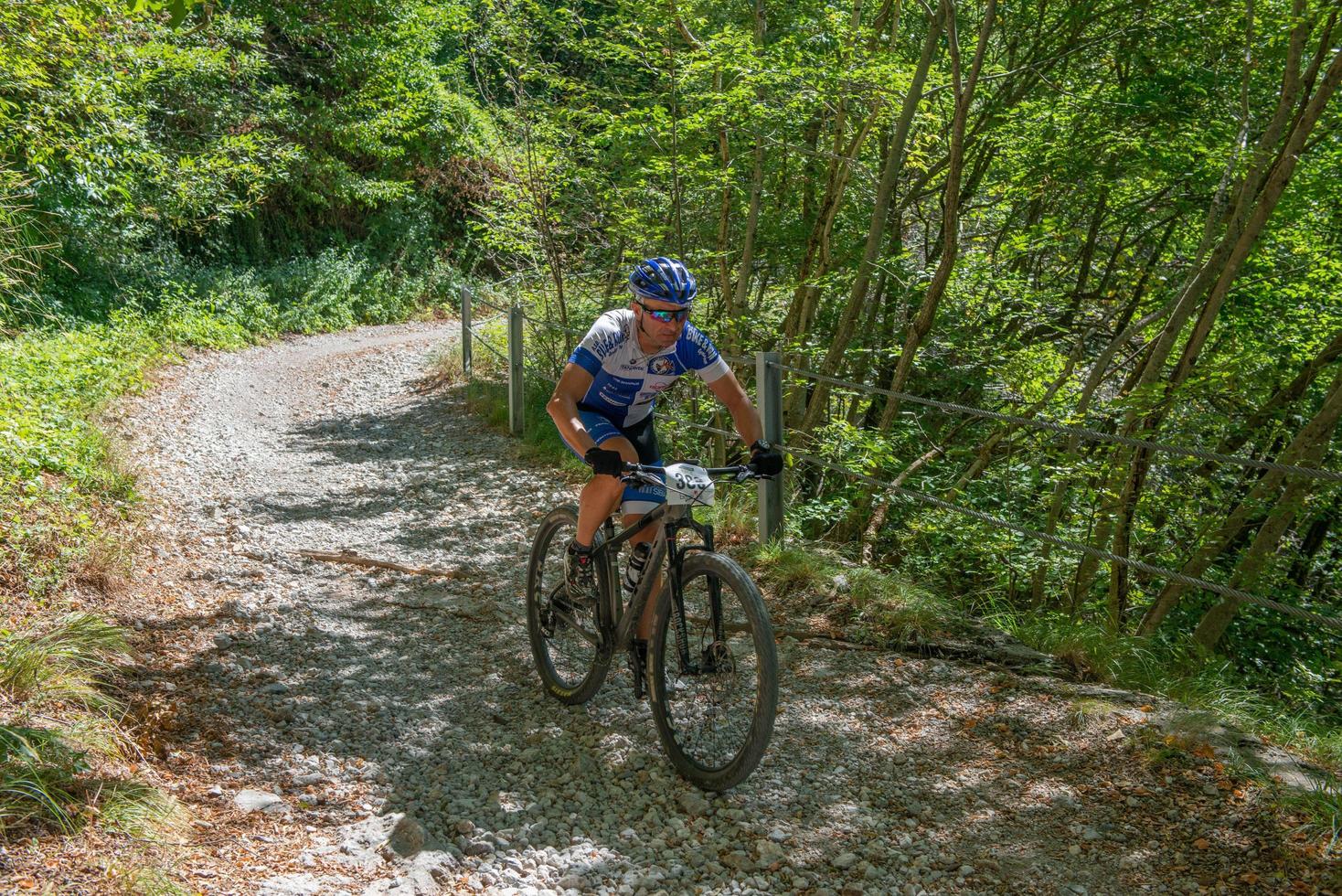 Italy  2022 Cyclists traveling on challenging trails on mountain bikes photo