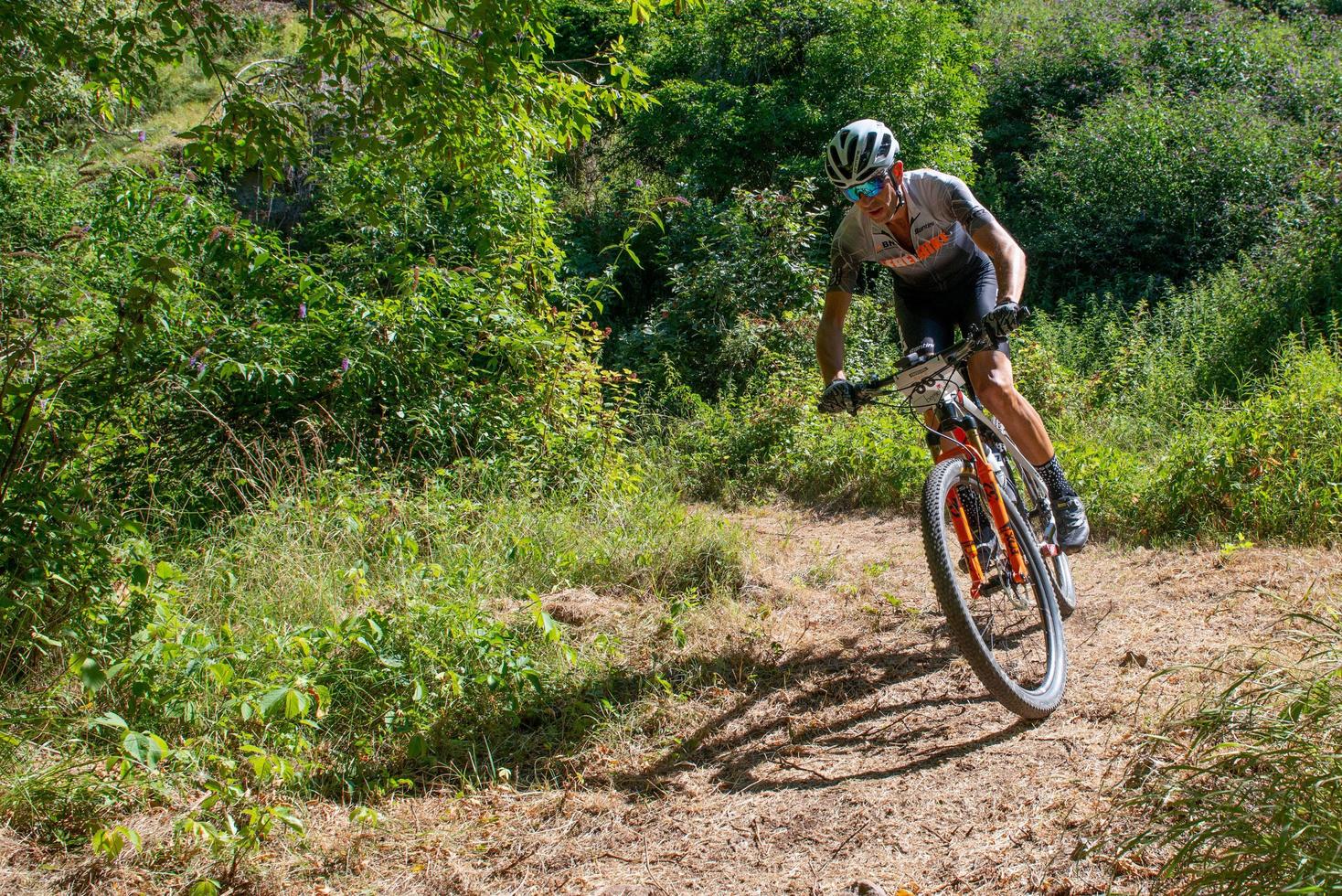 Italy  2022 Cyclists traveling on challenging trails on mountain bikes photo