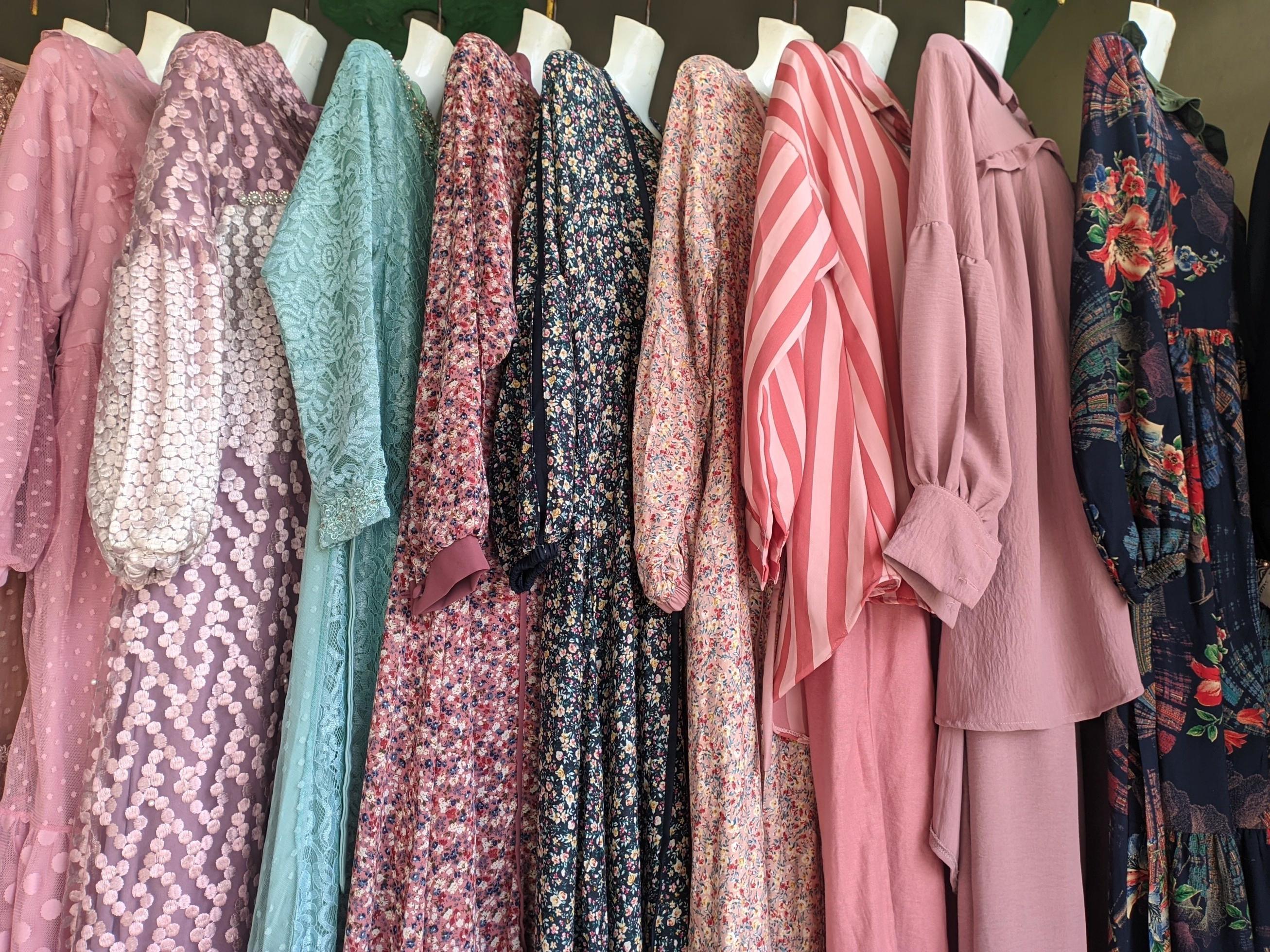 a collection of local women's clothing hanging and sold in