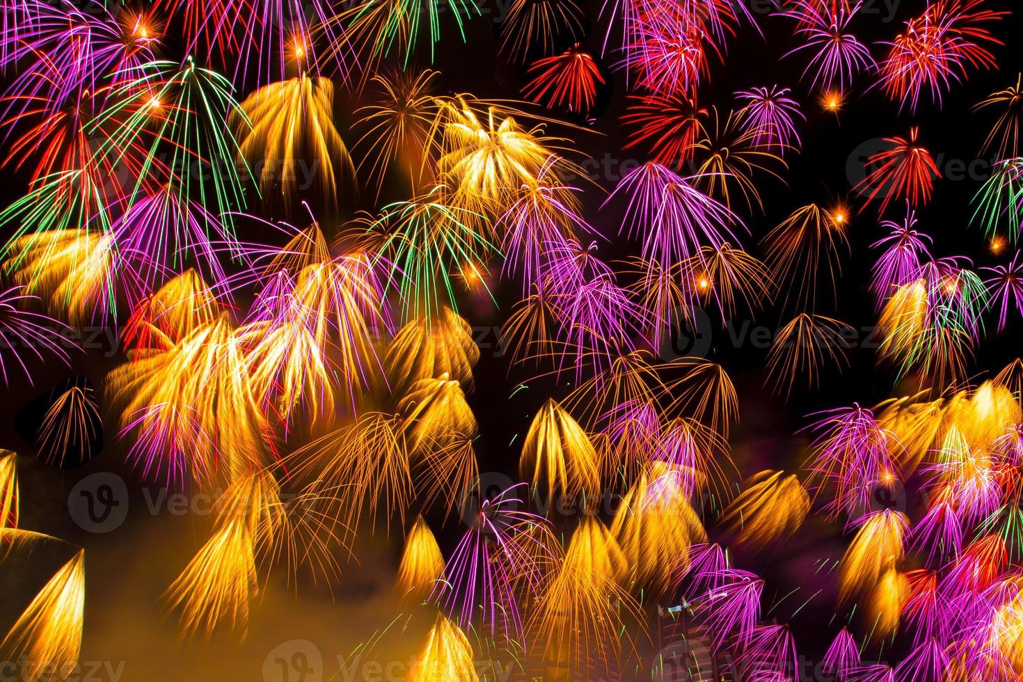 Colourful New Years Fireworks Display lighting up the night sky photo
