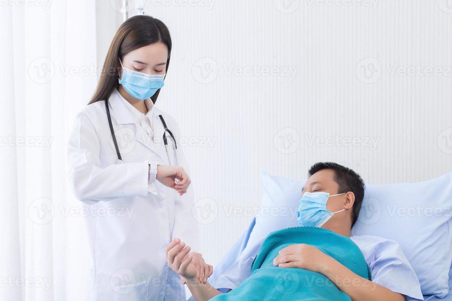 Asian woman doctor check the pulse of a man patient photo