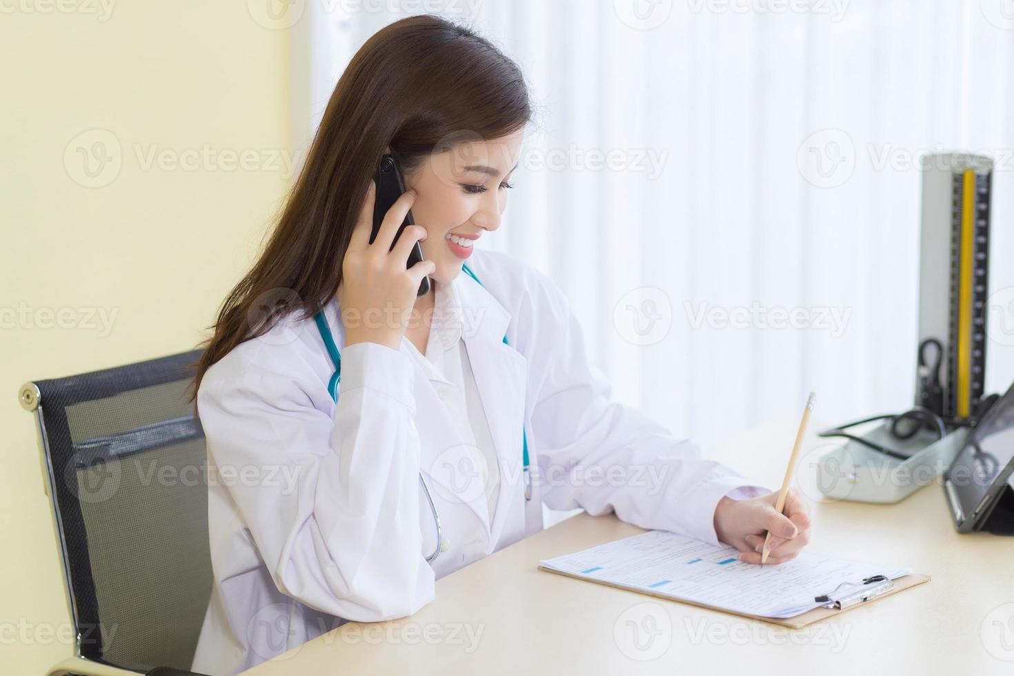 Asian female doctors provide telephone counseling photo