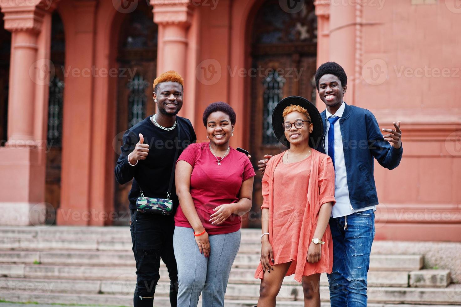 Four african friends having fun outdoors. Two black girls with guys. photo