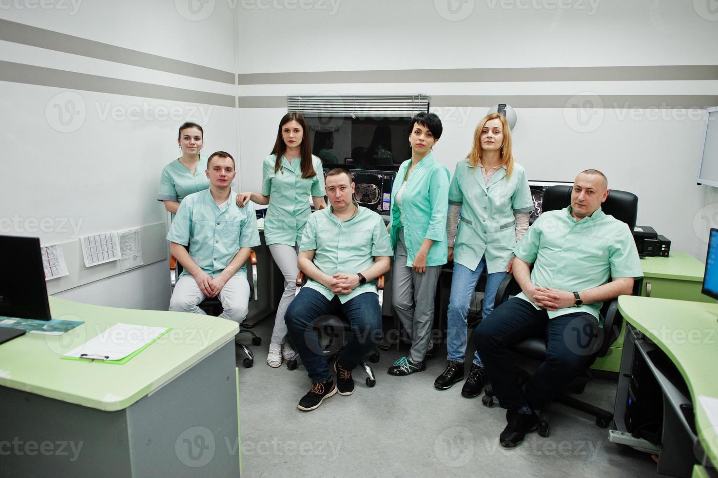 Medical theme.Observation room with a computer tomograph. The group of doctors meeting in the mri office at diagnostic center in hospital. photo