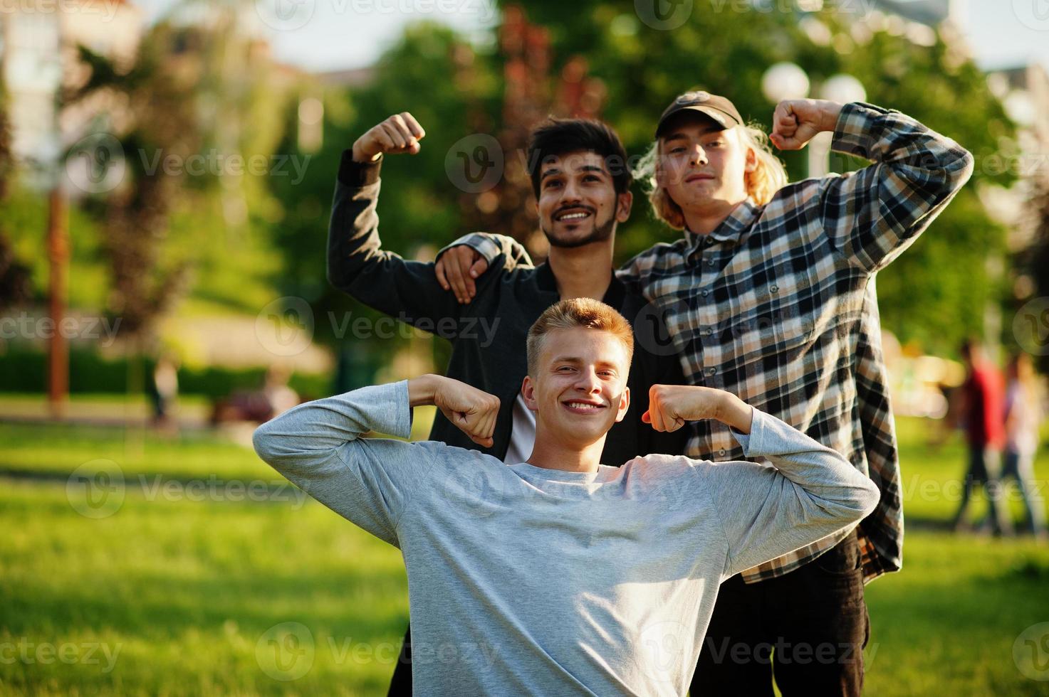 Three multi ethnic guys posed outdoor. photo