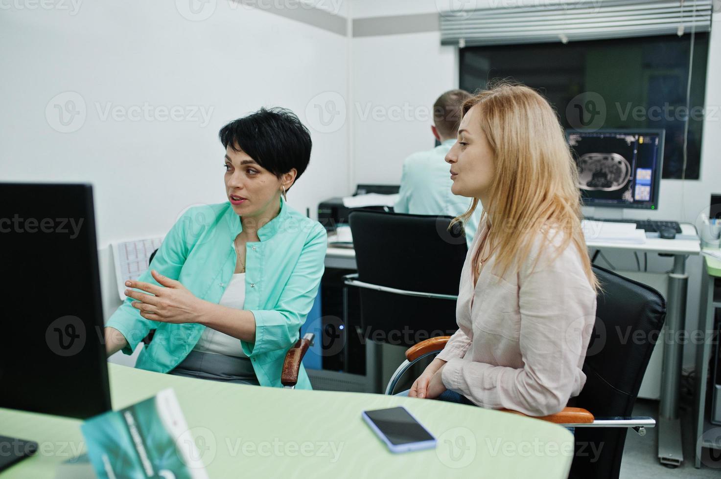 Medical theme. Observation room with a computer tomograph. Doctor advises the patient in the mri office at diagnostic center in hospital. photo