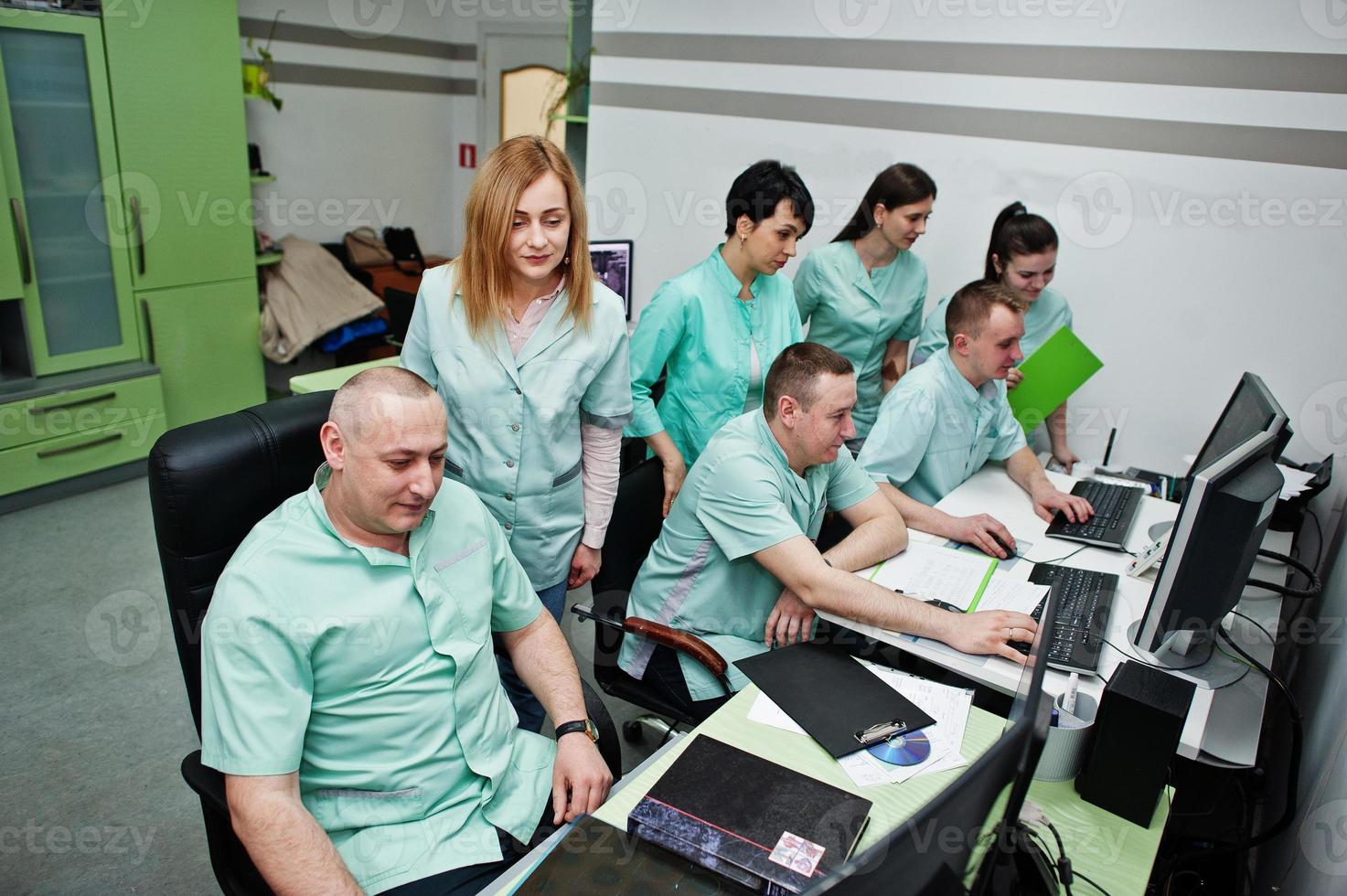 Medical theme.Observation room with a computer tomograph. The group of doctors meeting in the mri office at diagnostic center in hospital. photo