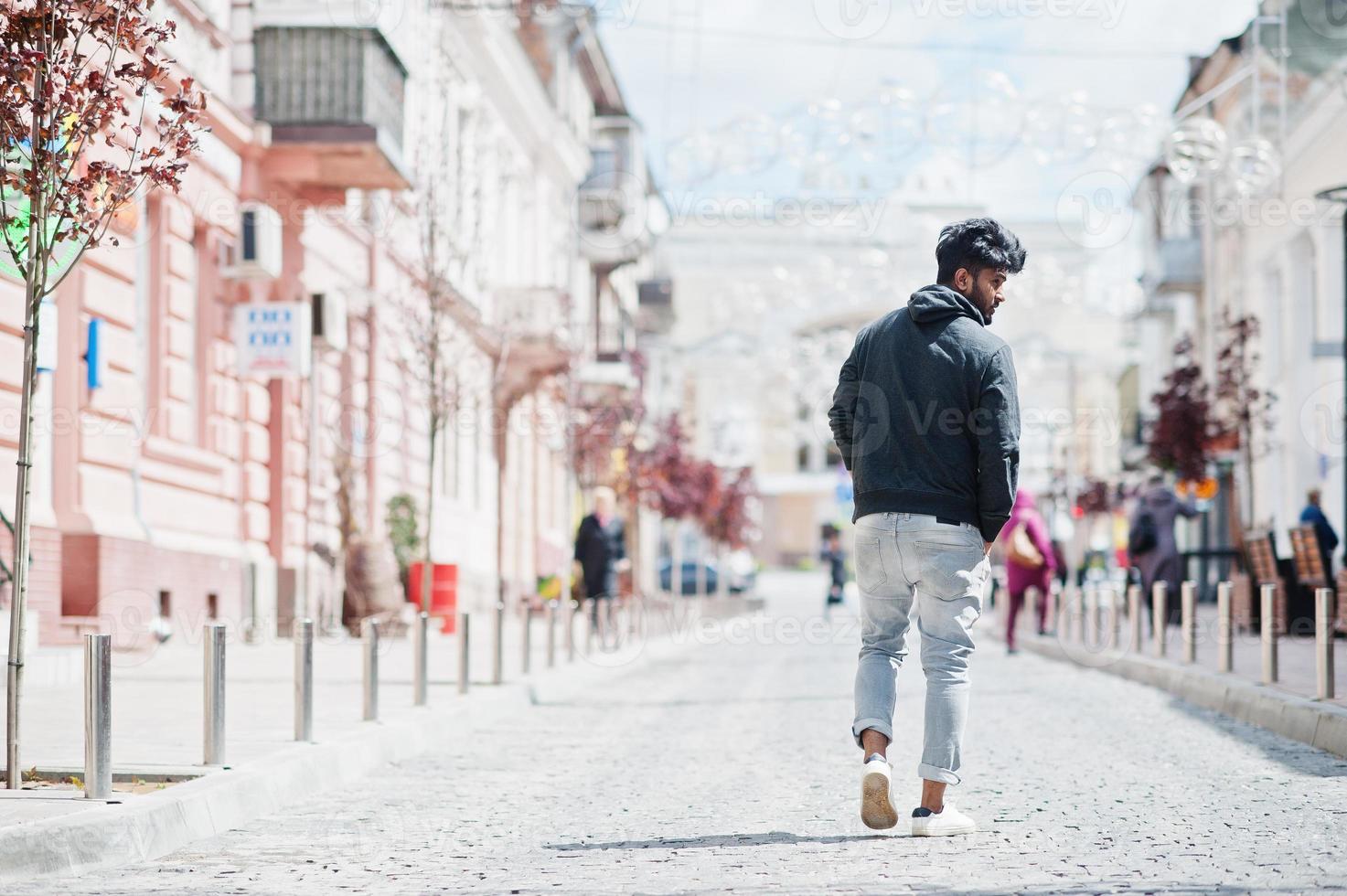 Portrait of young stylish indian man model pose in street. photo
