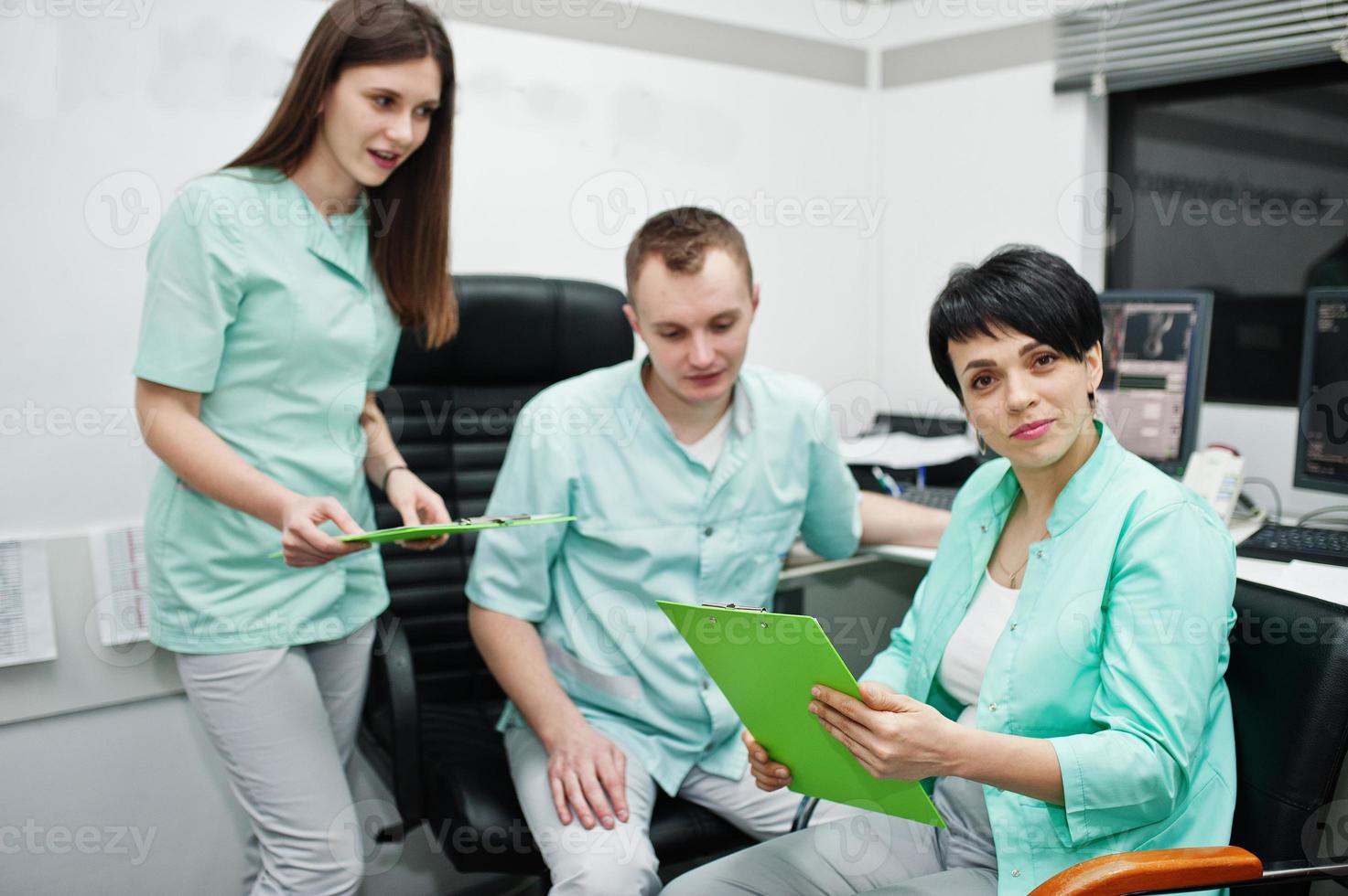 Medical theme.Observation room with a computer tomograph. The group of doctors meeting in the mri office at diagnostic center in hospital. photo
