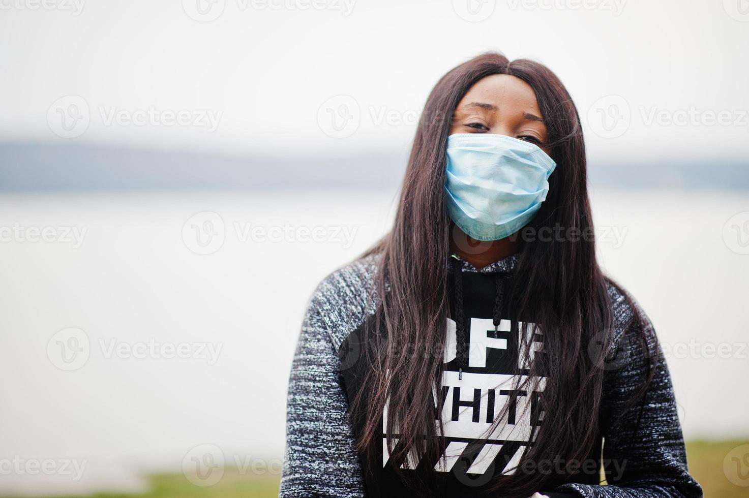 African girl at park wearing medical masks protect from infections and diseases coronavirus virus quarantine. photo