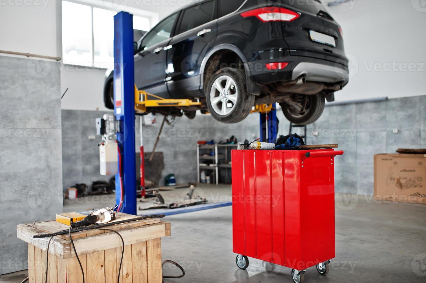 Car lifting in maintenance at garage service station. photo