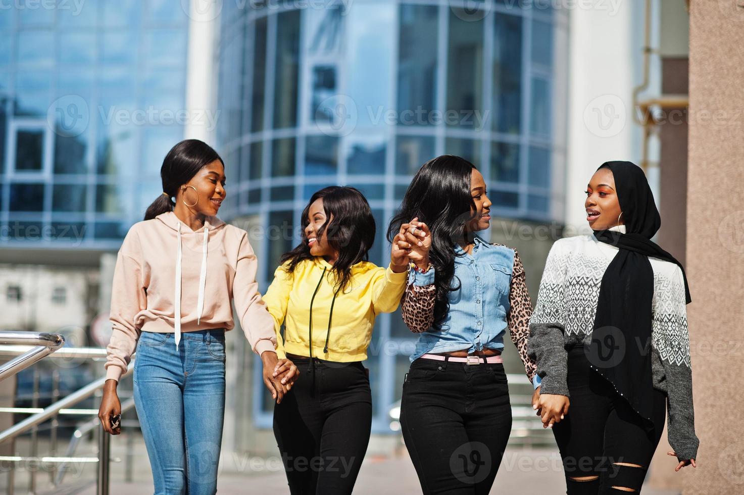 Four young college african american woman friends spend time together. photo