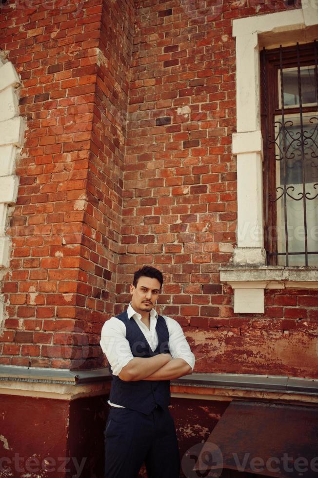 Portrait of retro 1920s english arabian business man wearing waistcoat. photo