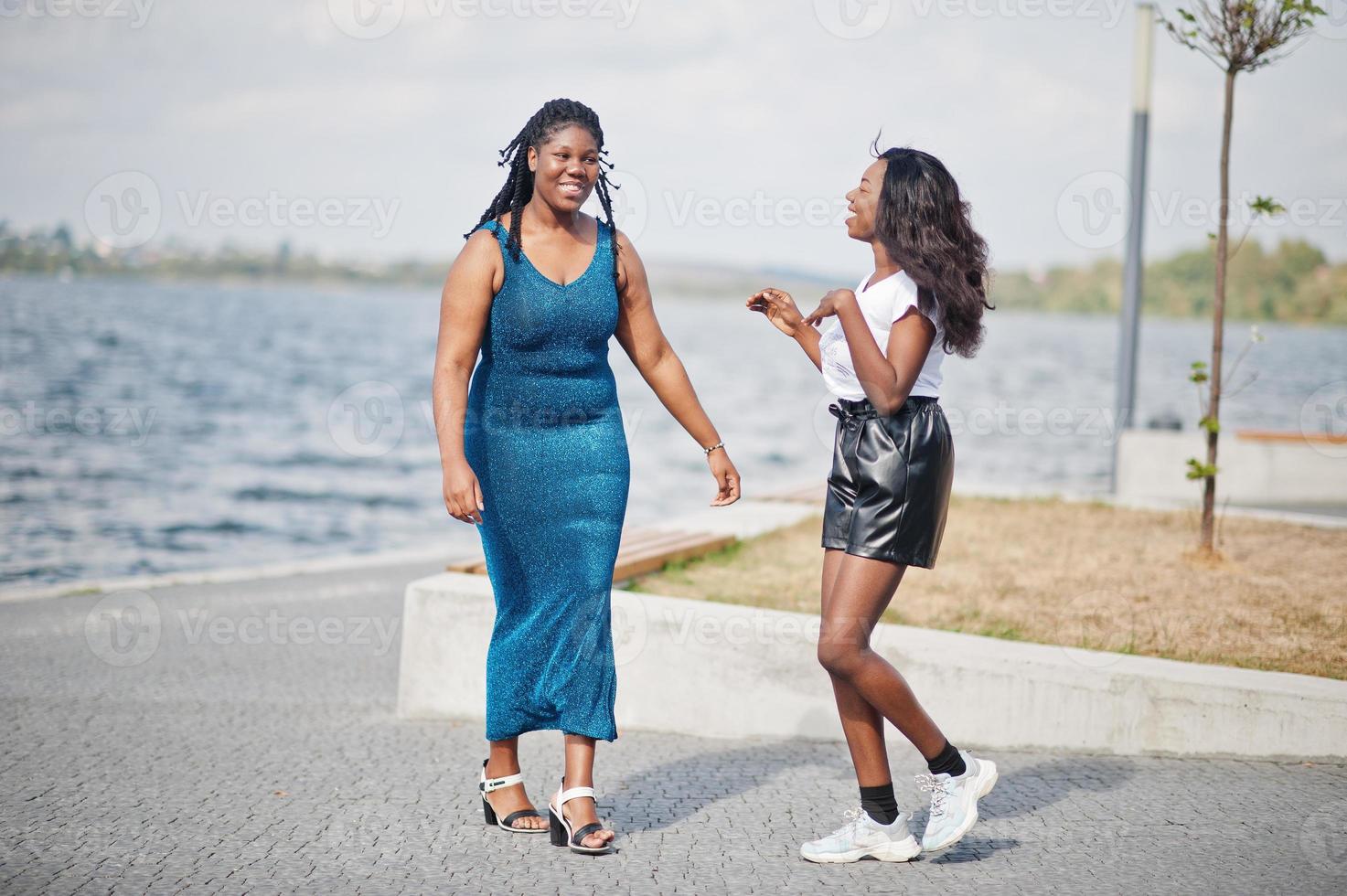 Two african american dark skinned friends female. One of them plus size model, second slim. Having fun and spending time together. photo