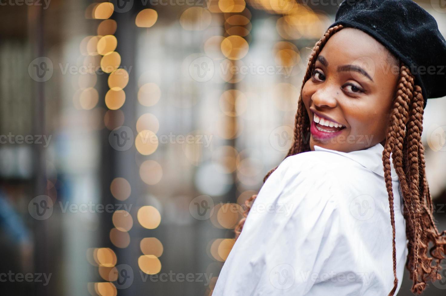 Close up portrait of african american woman in overalls and beret. photo