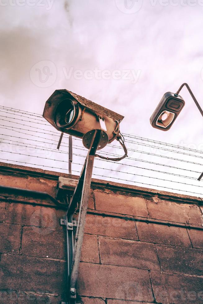 Security light on a perimeter wall with barb wire photo