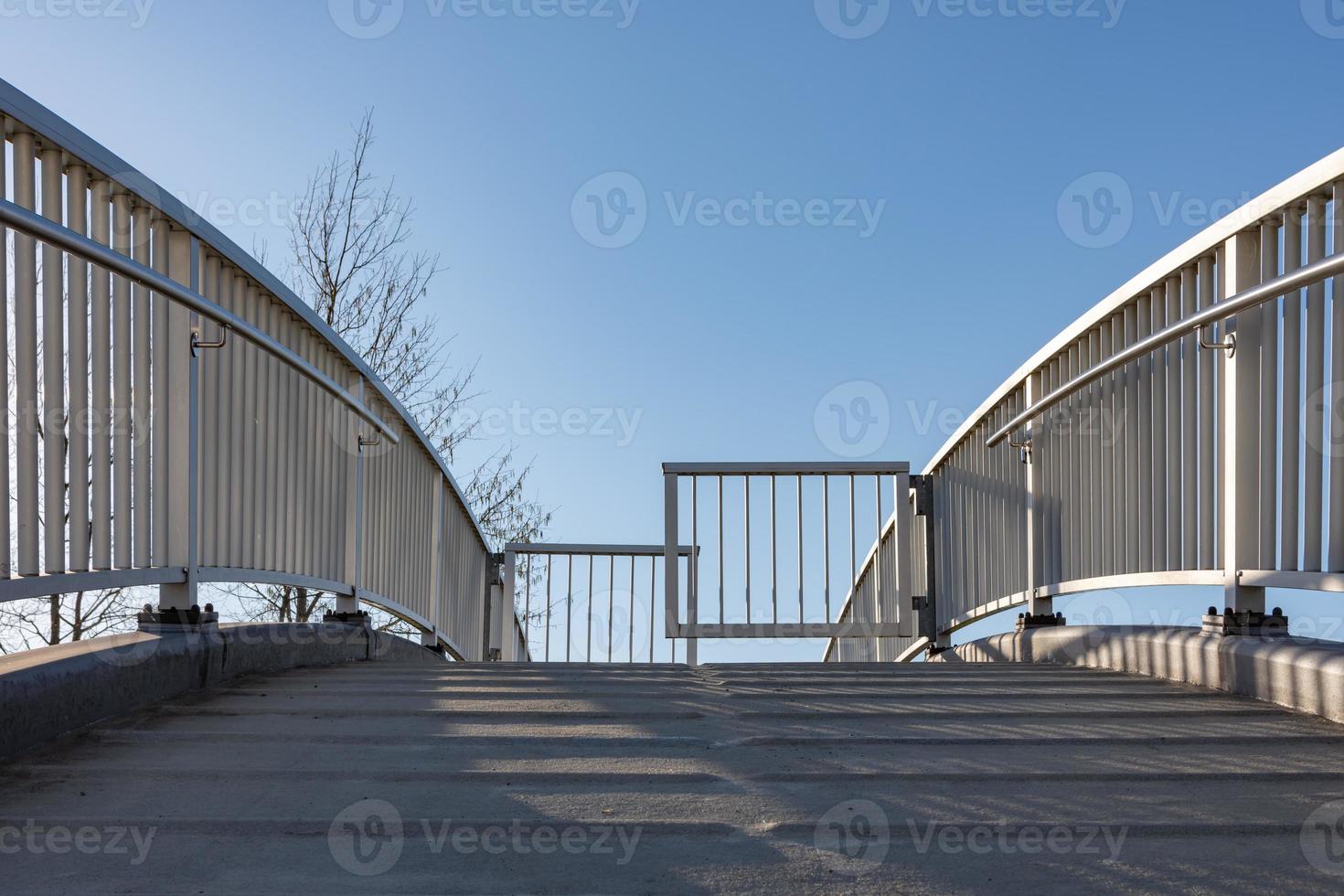 Pedestrian bridge with bicycle blocks photo