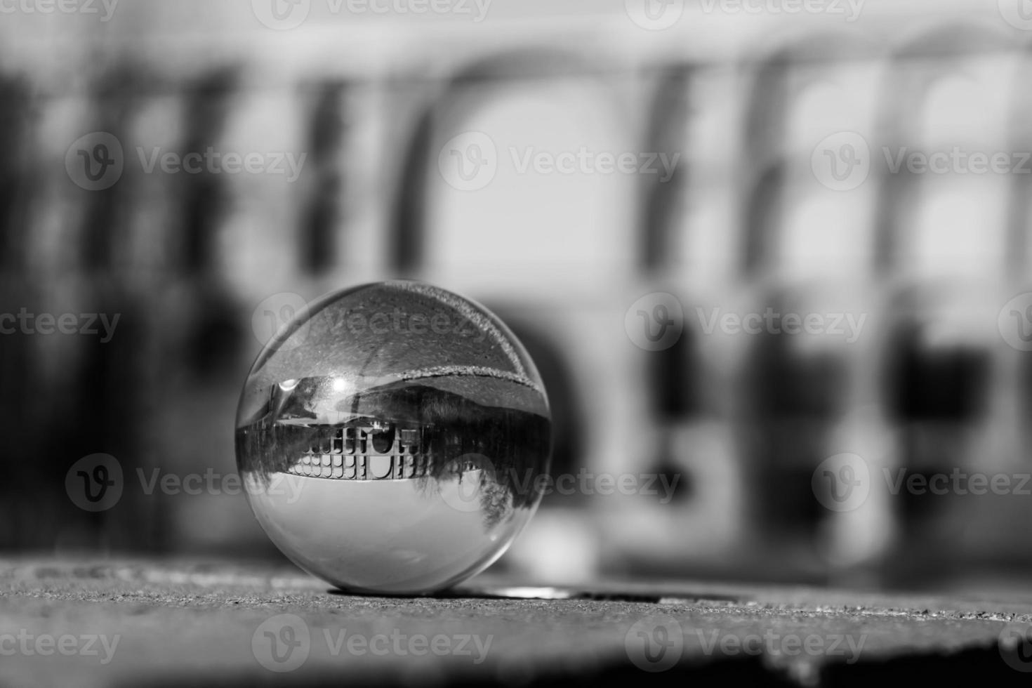 Glass ball in front of a bridge photo