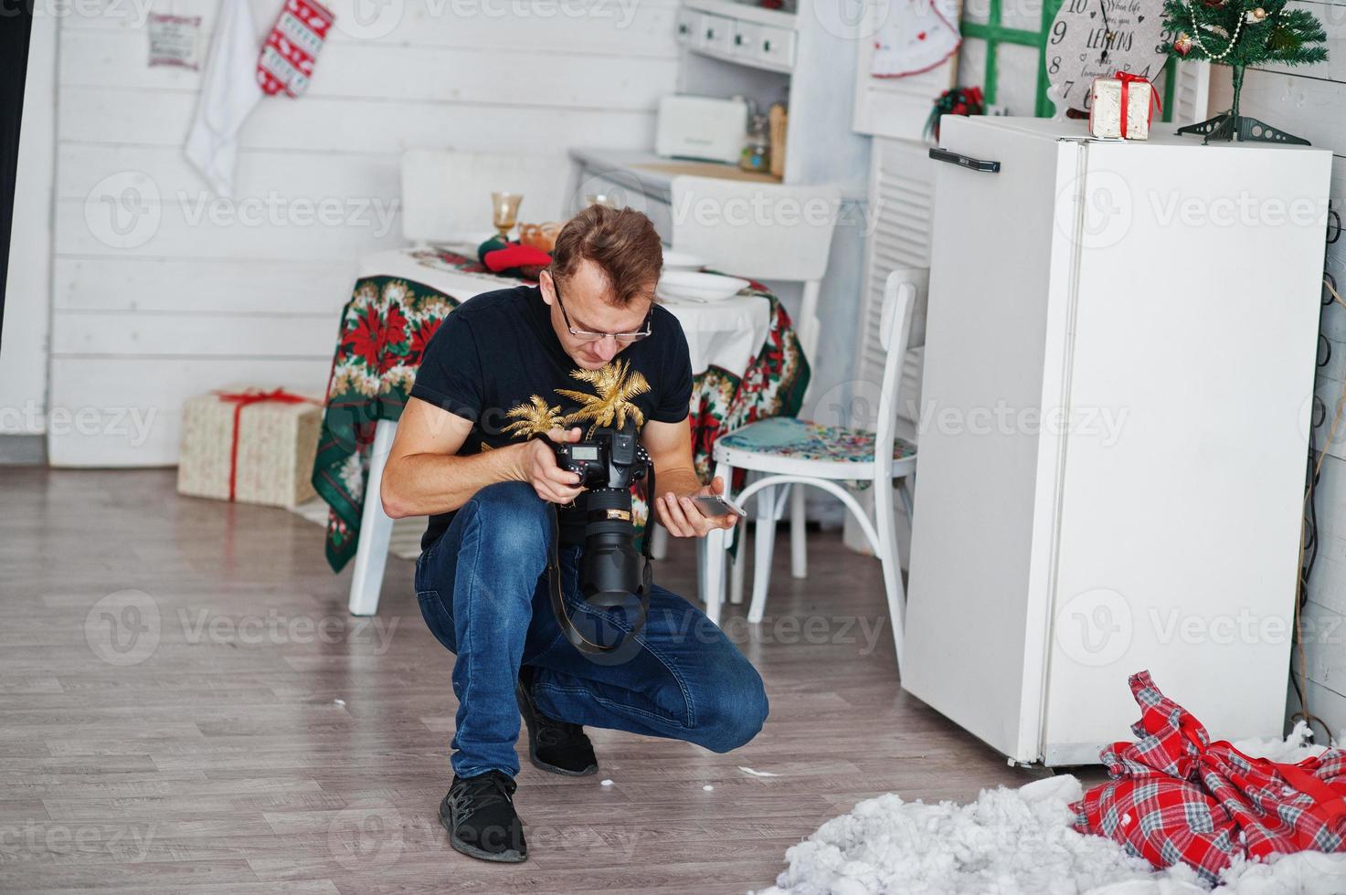 Man photographer looking at camera for result what him shoot on studio. Professional photographer on work. photo