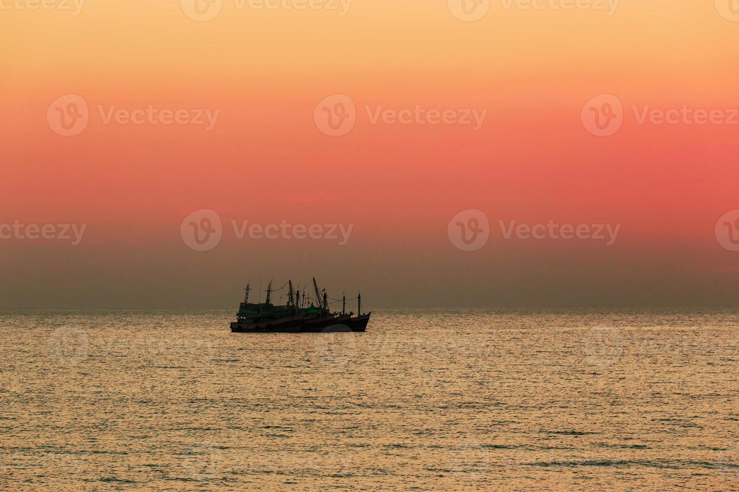 Fishing boat in sunset photo