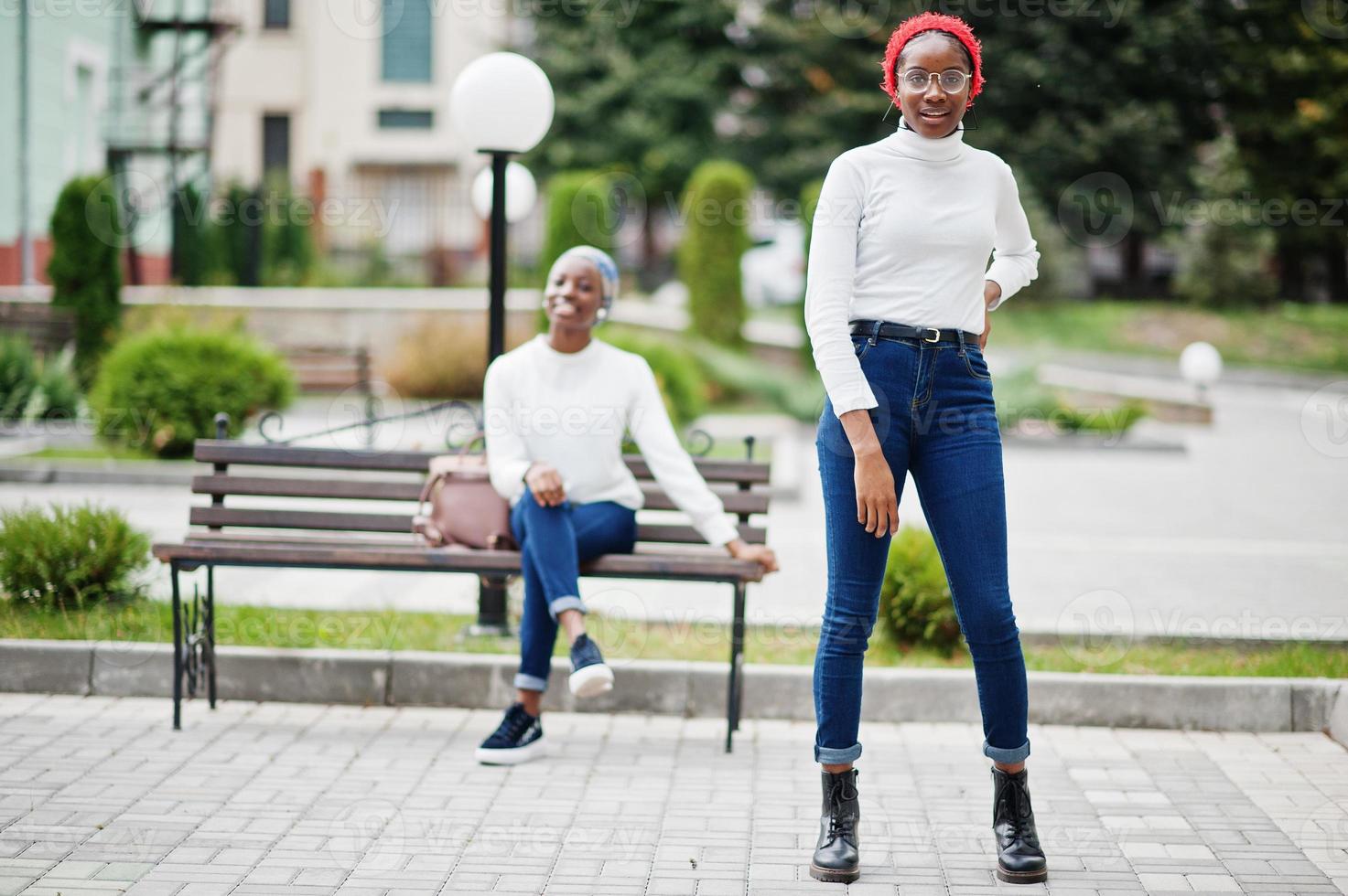 Two young modern fashionable, attractive, tall and slim african muslim womans in hijab or turban head scarf posed together. photo