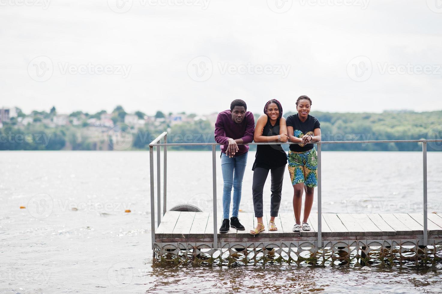 Three african american friends posed on pier. photo