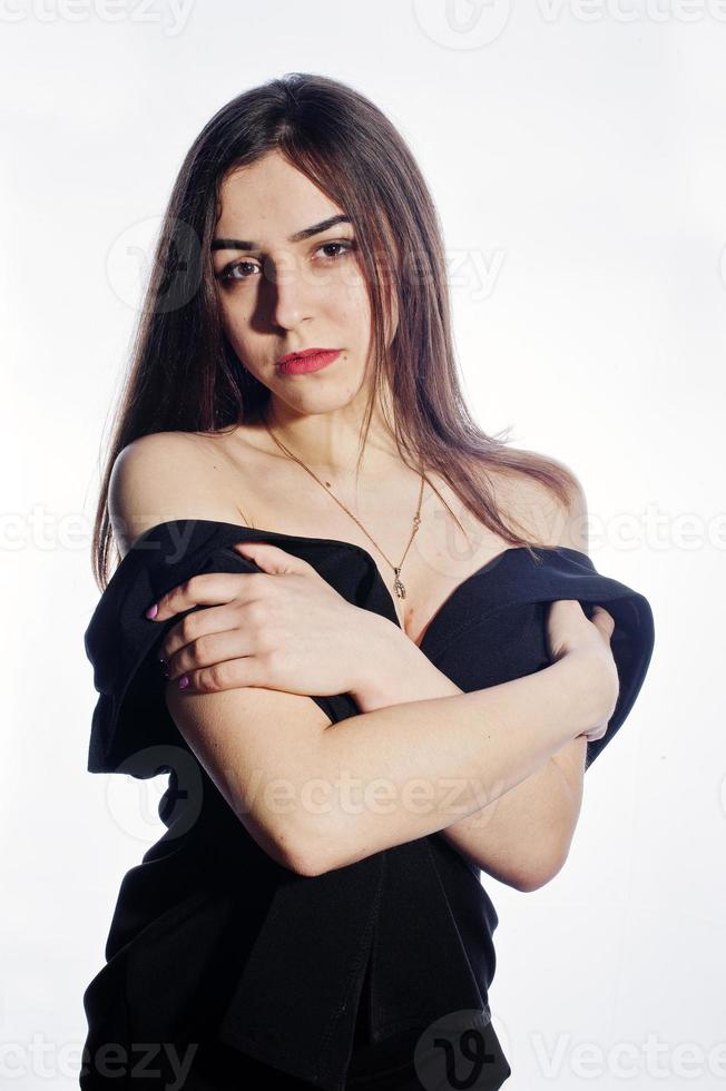 Close-up emotional portrait of a brunette girl in black jumpsuit on white background. photo