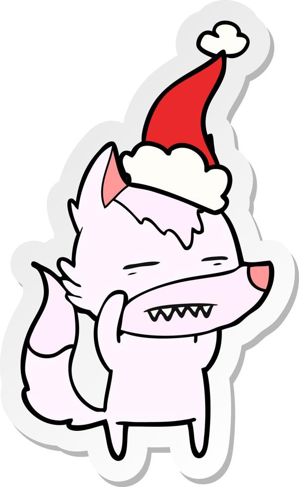 sticker cartoon of a wolf showing teeth wearing santa hat vector