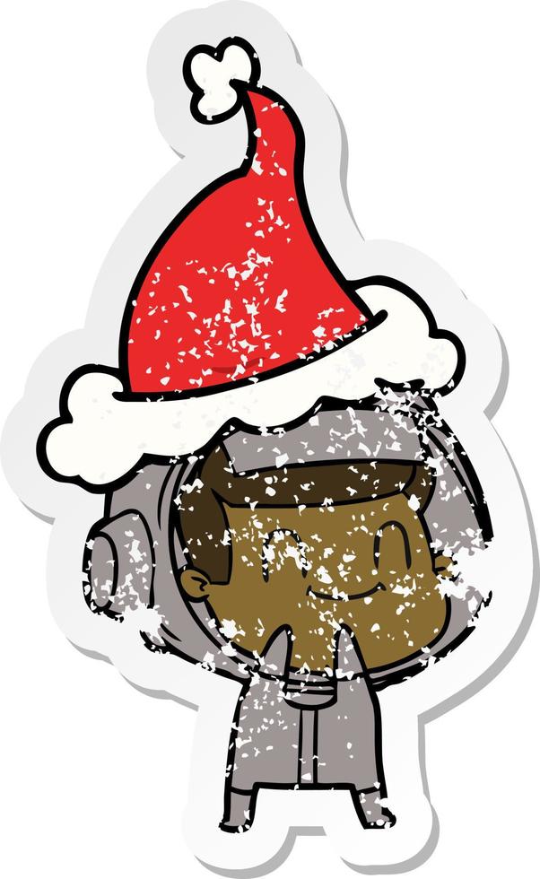 happy distressed sticker cartoon of a astronaut wearing santa hat vector