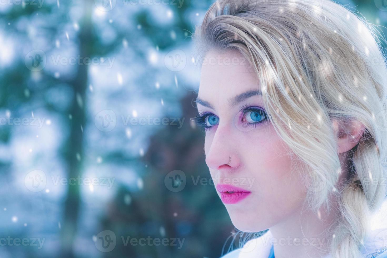 Beautiful young woman in winter snow photo