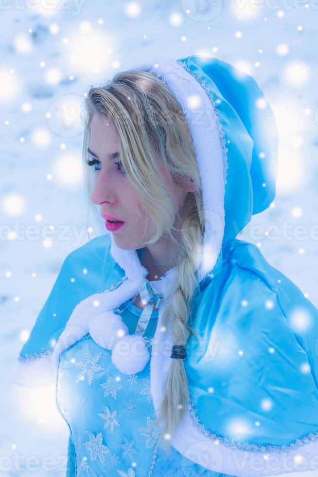 Beautiful young woman in winter snow photo