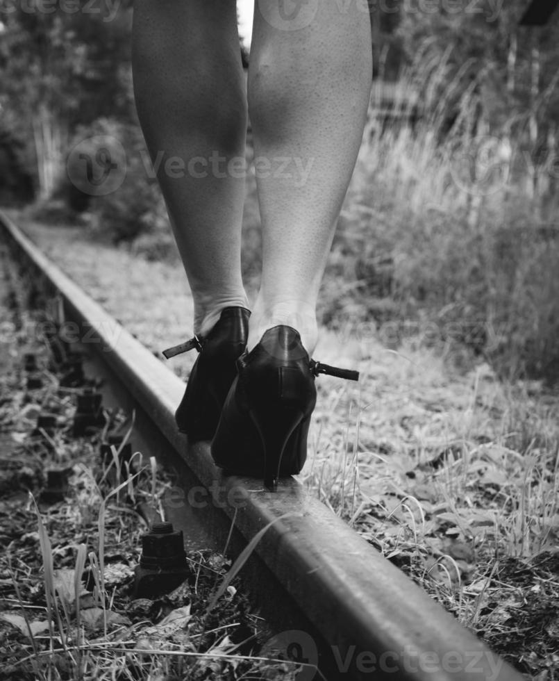 Woman with high heels on a railway track photo