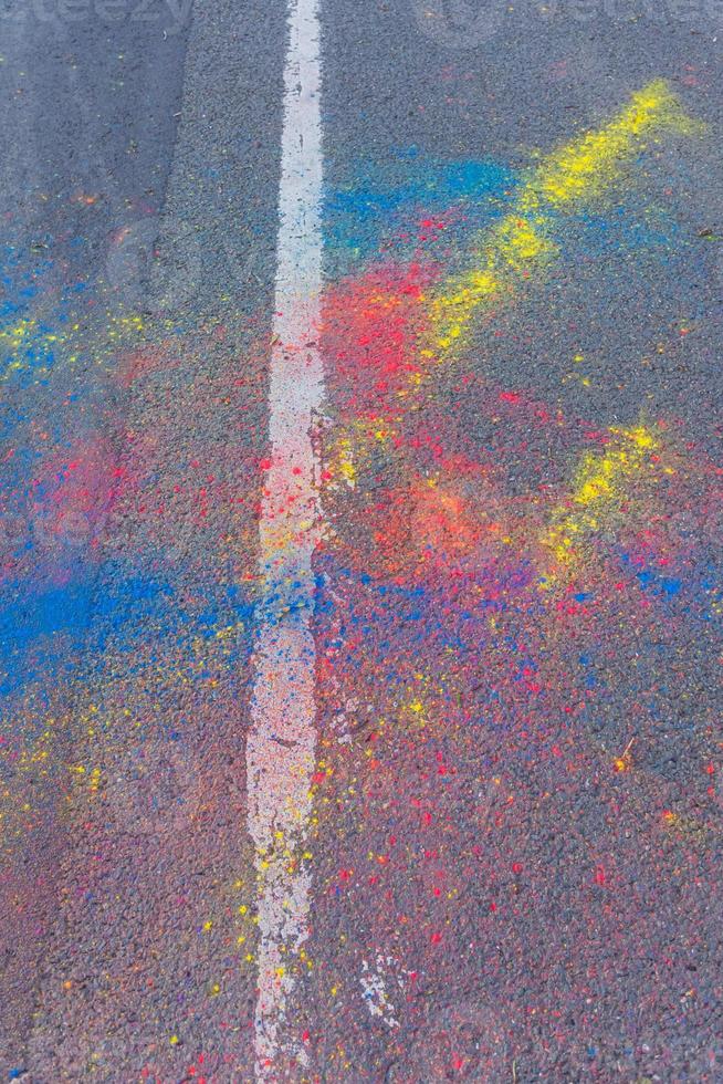 Colorful Holi powder scattered on a road photo