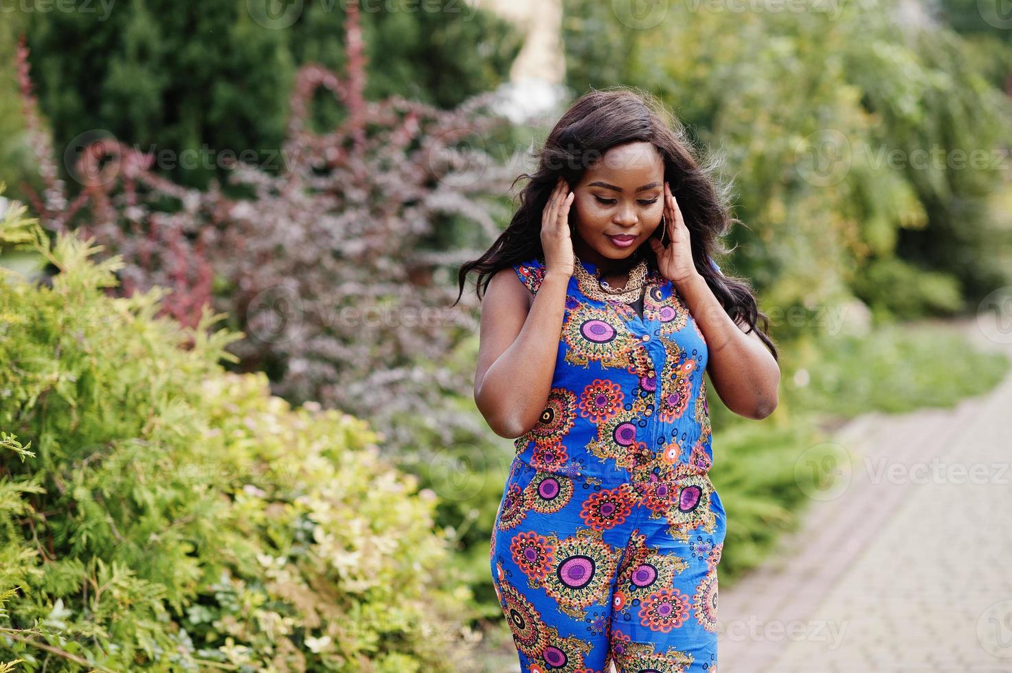 African american girl in coloured clothes posed outdoor. Fashionable black woman. photo