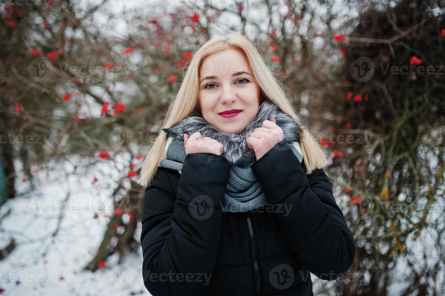 Blonde girl posed at winter snowy day. photo