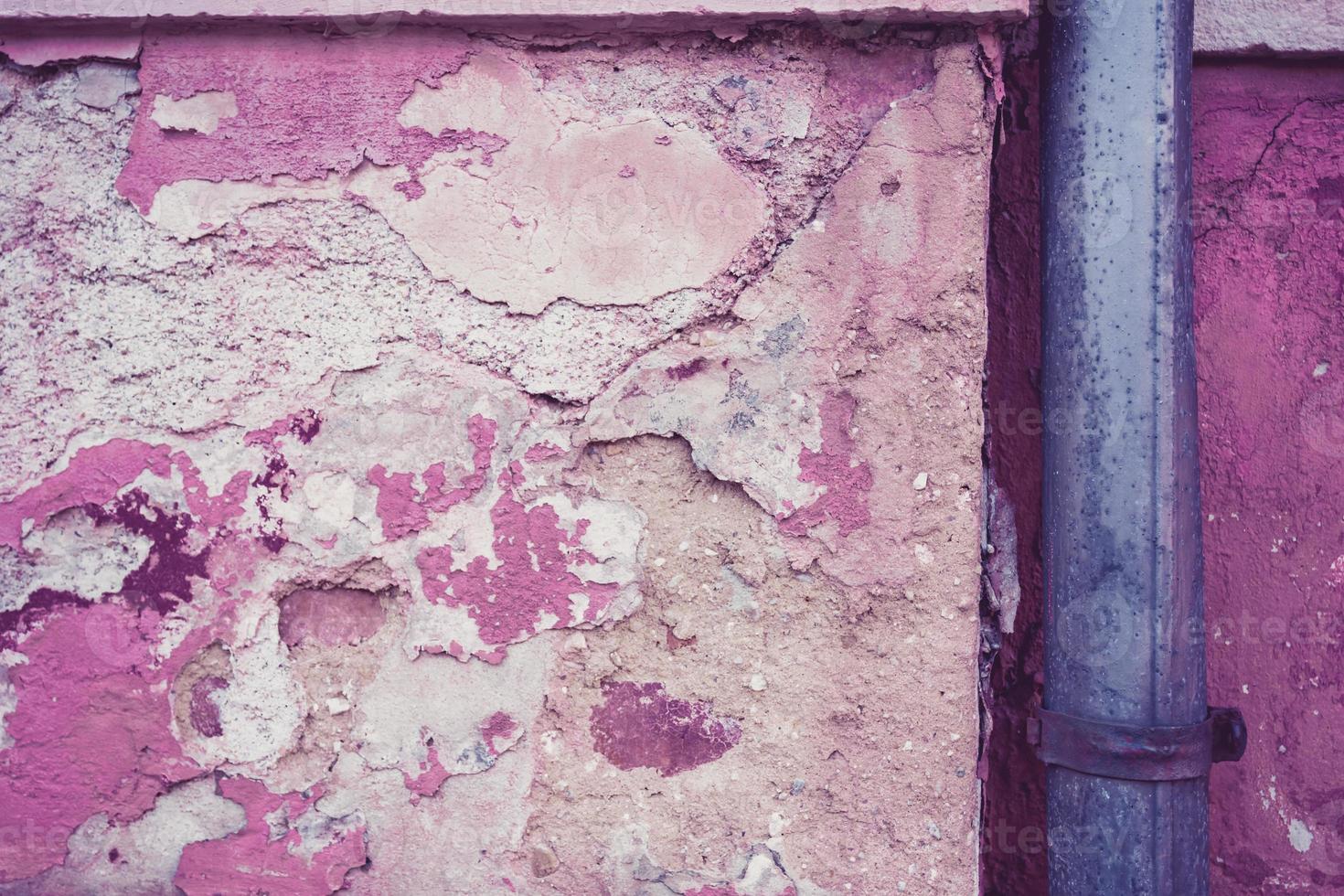 gutter in front of an old wall photo