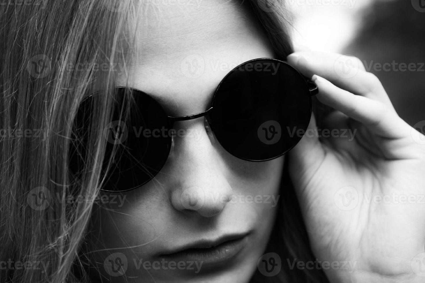 Trendy young woman wearing sunglasses photo