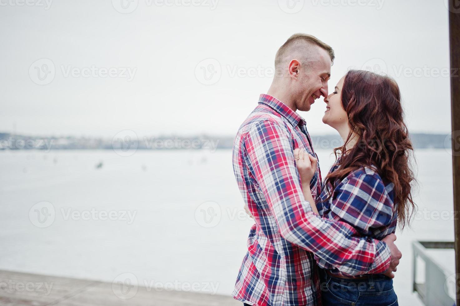 Stylish couple wear on checkered shirt in love together. photo