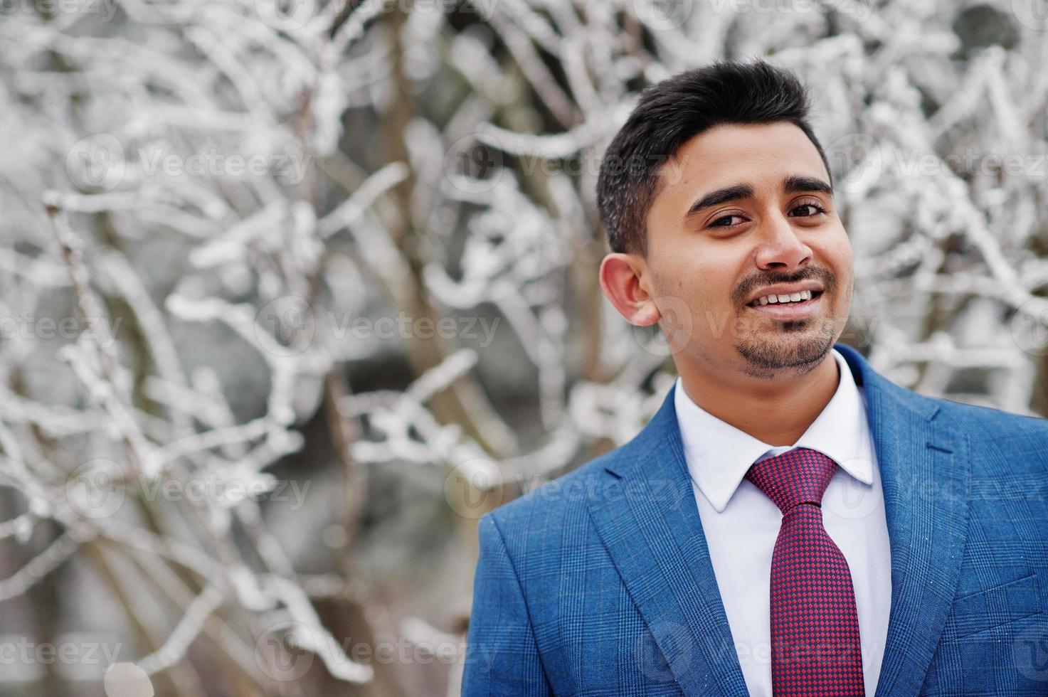 Elegant indian fashionable man model on suit posed at winter day. photo