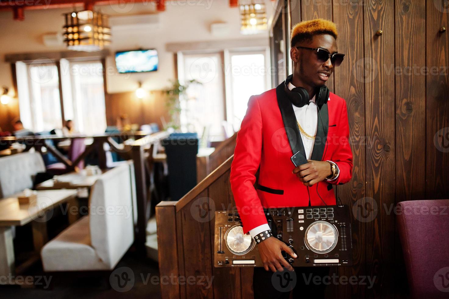 Fashion african american man model DJ at red suit with dj controller. photo