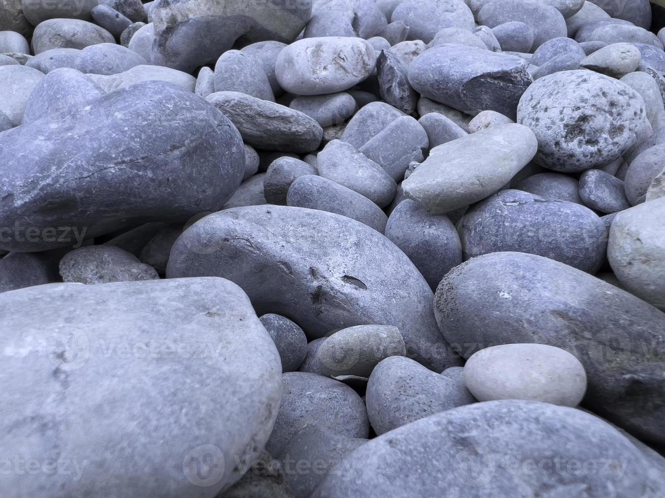 Smooth gray pebbles on the beach, stones pattern and texture, zen meditation, natural background. photo