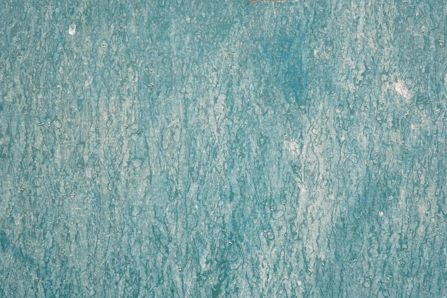 Painted in turquoise color wet wooden wall, dirty board surface, texture and pattern, grunge background, weathered building facade. photo