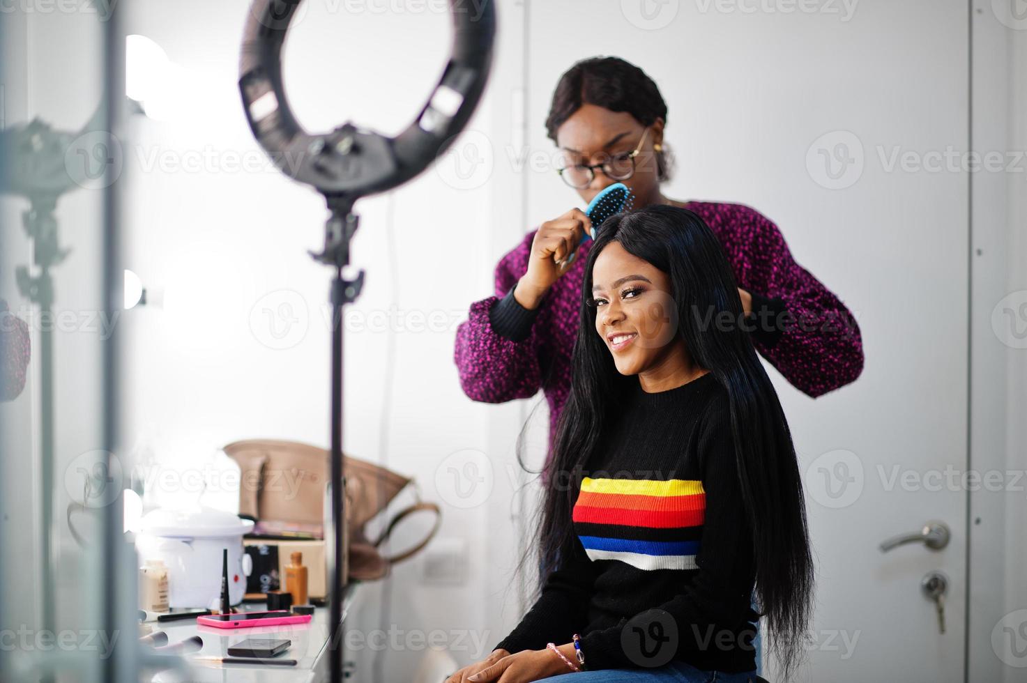 African American woman applying hairdresser or hairstylist at beauty saloon. photo