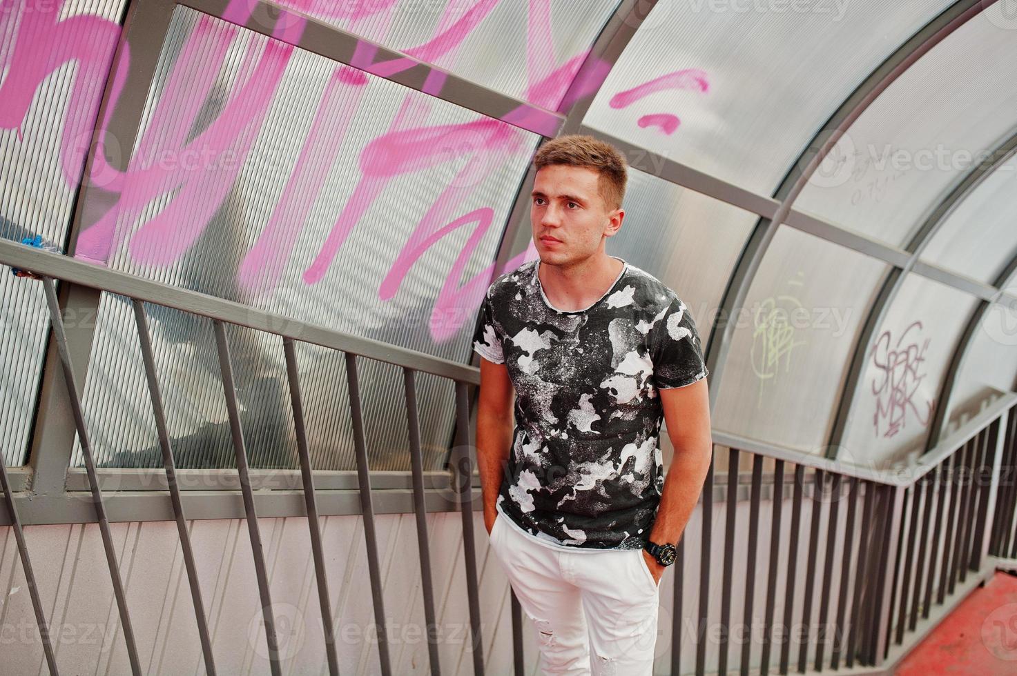 Lifestyle portrait of handsome man posing on the city tonnel. photo