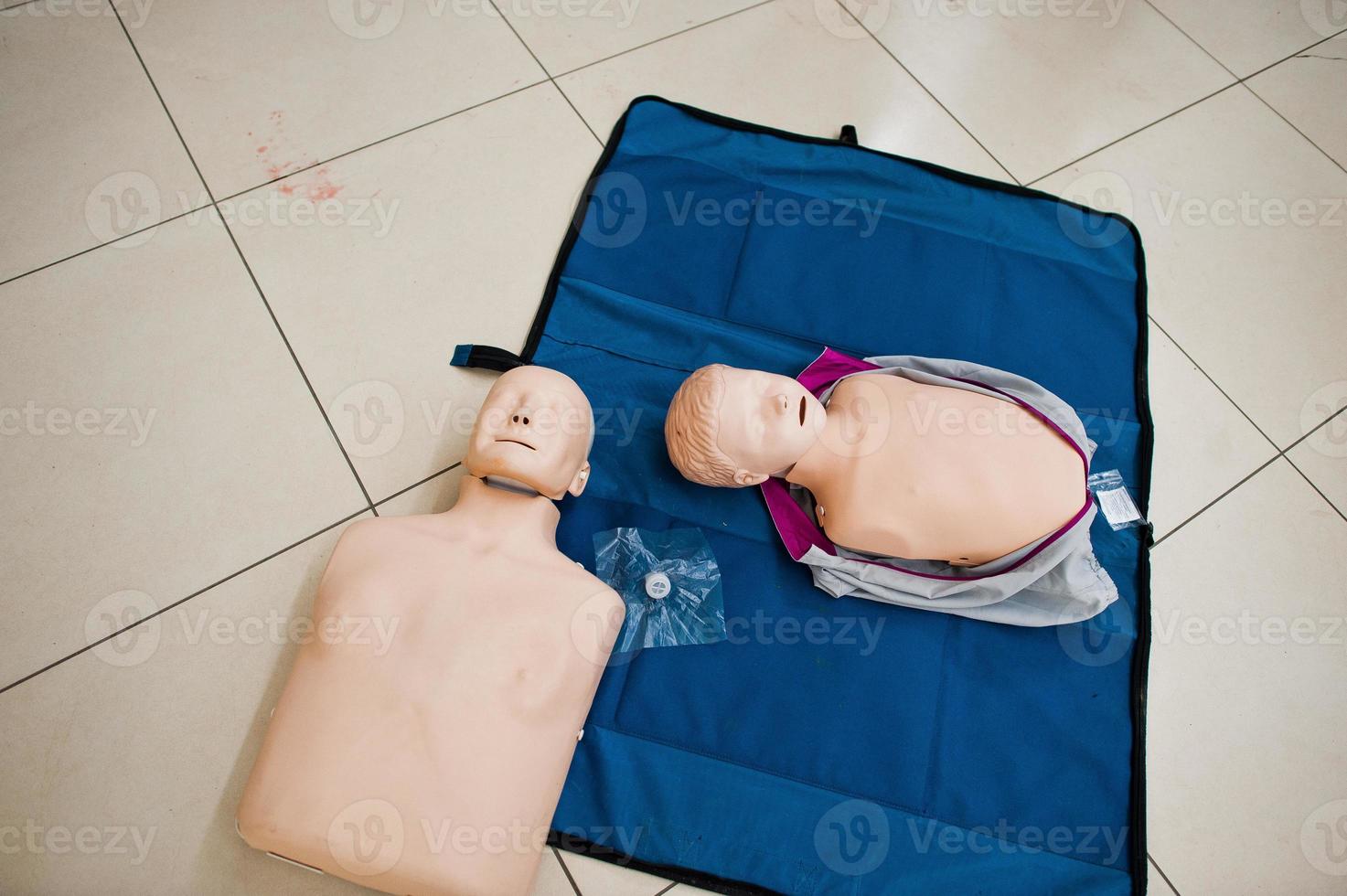 Close-up photo of CPR dolls or mannequins on the floor.