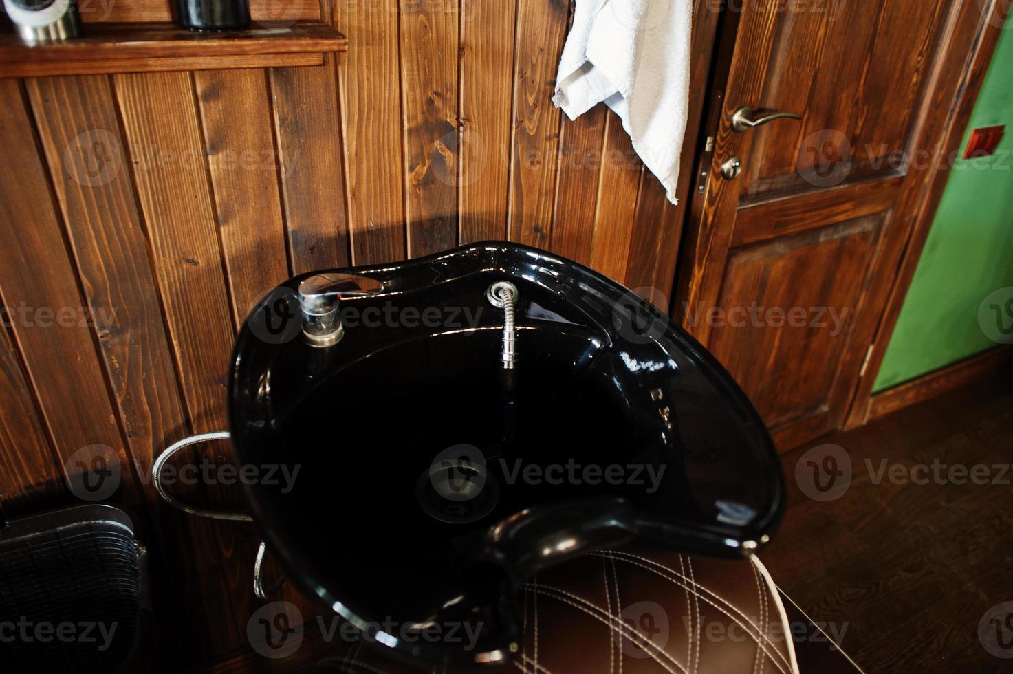 Black washbasin or sink at barber shop. photo