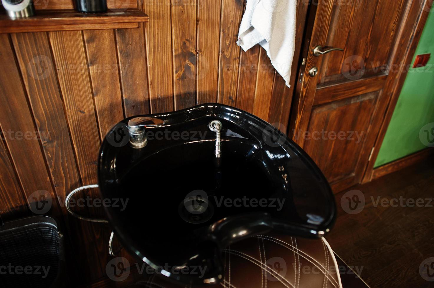 Black washbasin or sink at barber shop. photo