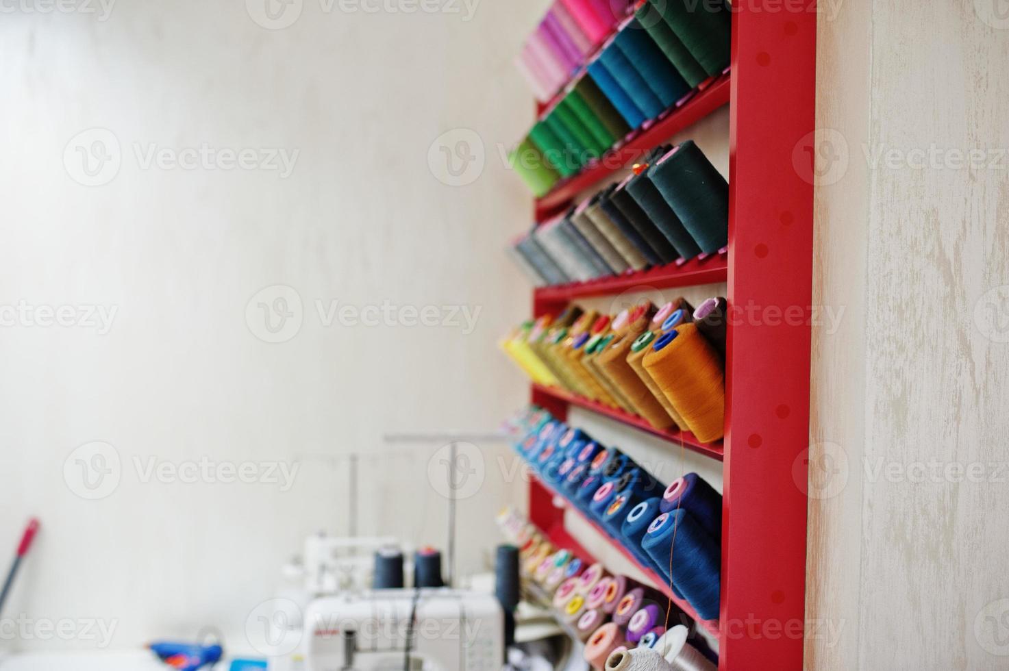 Colored thread coils on seamstess background, sewing. photo