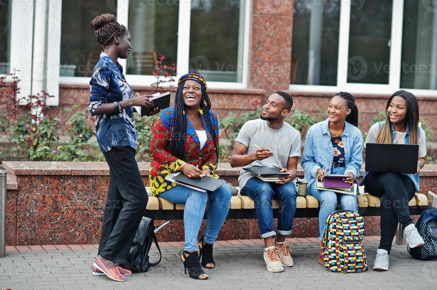 Group of five african college students spending time together on campus